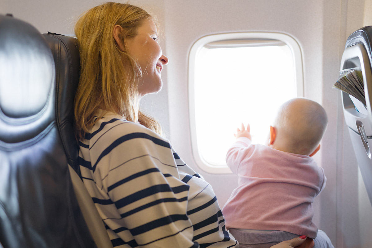 Mamma e neonato seduti in aereo - neonati in aereo